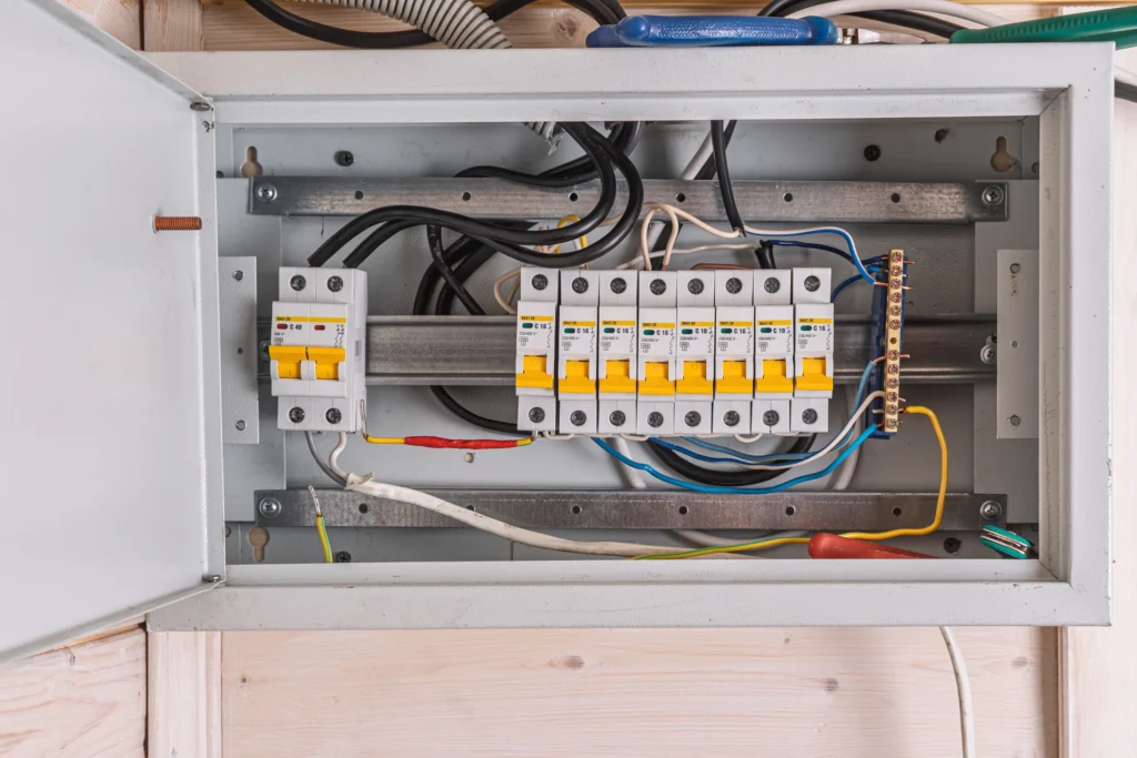 Open the electrical distribution box. The circuit breakers on the panel are neatly arranged in order